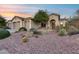 Beautiful front yard featuring well maintained desert landscaping and a charming home at 42001 N Bridlewood Way, Phoenix, AZ 85086