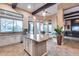 Gourmet kitchen with large granite island, stainless steel appliances, and adjacent breakfast nook at 42001 N Bridlewood Way, Phoenix, AZ 85086