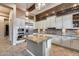 Modern kitchen with stainless steel appliances, granite island, and ample cabinet space for storage at 42001 N Bridlewood Way, Phoenix, AZ 85086