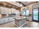 Modern kitchen with stainless steel appliances, a large island, and elegant backsplash for cooking enjoyment at 42001 N Bridlewood Way, Phoenix, AZ 85086