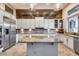 Bright kitchen with a large island, stainless steel appliances, white cabinets, and statement backsplash at 42001 N Bridlewood Way, Phoenix, AZ 85086