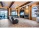 Spacious living room featuring beamed ceilings, a modern fireplace and tile flooring at 42001 N Bridlewood Way, Phoenix, AZ 85086