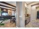 Open concept living room featuring hardwood floors, fireplace, wood beam ceilings and wet bar for entertaining at 42001 N Bridlewood Way, Phoenix, AZ 85086