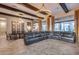 Expansive living room with wooden beams, tiled flooring, large seating area, and view of dining room at 42001 N Bridlewood Way, Phoenix, AZ 85086