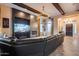 Spacious living room featuring a fireplace, TV, wood beam ceilings, stylish lighting, and comfortable seating at 42001 N Bridlewood Way, Phoenix, AZ 85086
