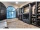 Bright office with a beautiful arched window and custom built-in bookshelves for storage and display at 42001 N Bridlewood Way, Phoenix, AZ 85086