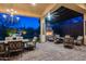 Covered patio with a fireplace, seating, and view of the water feature at 42001 N Bridlewood Way, Phoenix, AZ 85086