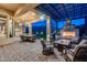 Luxury outdoor living space featuring a covered patio with a fireplace and comfortable seating at 42001 N Bridlewood Way, Phoenix, AZ 85086