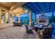 Spacious patio featuring an outdoor fireplace, multiple seating areas, and desert landscaping at 42001 N Bridlewood Way, Phoenix, AZ 85086