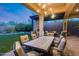 Elegant patio with an outdoor dining table, fireplace, and comfortable seating area at 42001 N Bridlewood Way, Phoenix, AZ 85086
