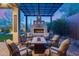Charming patio featuring a stone fireplace and comfortable outdoor seating area at 42001 N Bridlewood Way, Phoenix, AZ 85086