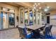 Inviting patio with an outdoor dining table and a view into the home's modern kitchen at 42001 N Bridlewood Way, Phoenix, AZ 85086