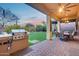 Outdoor patio with BBQ area, dining set, covered area with ceiling fan, and landscaped backyard at 42001 N Bridlewood Way, Phoenix, AZ 85086
