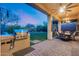 Covered patio with outdoor kitchen, ceiling fan, chandelier and ample seating area at 42001 N Bridlewood Way, Phoenix, AZ 85086