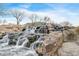 Scenic waterfall cascading over rocks, creating a tranquil water feature in a community space at 42001 N Bridlewood Way, Phoenix, AZ 85086