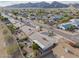This aerial view shows a community neighborhood with desert landscaping, and mountain views at 4401 E Walatowa St, Phoenix, AZ 85044