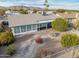 A landscaped backyard features privacy landscaping, a covered patio, and desert scape at 4401 E Walatowa St, Phoenix, AZ 85044