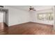 Bedroom with wood-look floors, ceiling fan, and backyard view at 4401 E Walatowa St, Phoenix, AZ 85044