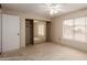 Bedroom featuring carpet, ceiling fan, and large mirrored closet at 4401 E Walatowa St, Phoenix, AZ 85044