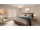 Serene bedroom with a cozy chair, neutral color scheme, and lots of natural light at 4401 E Walatowa St, Phoenix, AZ 85044