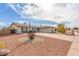 Wide view of home featuring desert landscaping and spacious driveway at 4401 E Walatowa St, Phoenix, AZ 85044