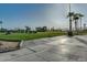 Scenic golf course view features lush green grass, palm trees and the driving range with distant mountain views at 4401 E Walatowa St, Phoenix, AZ 85044