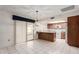 Bright kitchen boasts white appliances, tile floors and convenient breakfast bar at 4401 E Walatowa St, Phoenix, AZ 85044