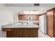 Open kitchen area offers a breakfast bar, white appliances and plenty of counter space at 4401 E Walatowa St, Phoenix, AZ 85044