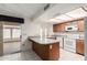 Open kitchen area with breakfast bar, tile floors, and access to the backyard at 4401 E Walatowa St, Phoenix, AZ 85044