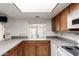 Well-lit kitchen featuring oak cabinets, neutral countertops, and white appliances at 4401 E Walatowa St, Phoenix, AZ 85044