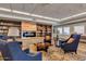 Cozy library featuring a fireplace, comfortable armchairs, and extensive built-in bookshelves at 4401 E Walatowa St, Phoenix, AZ 85044