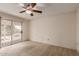 Bedroom with sliding glass doors leading to an outdoor patio and ceiling fan at 4401 E Walatowa St, Phoenix, AZ 85044