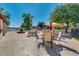 Relaxing pool area with tables, chairs, shade umbrellas, and lush landscaping at 4401 E Walatowa St, Phoenix, AZ 85044