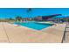 Outdoor swimming pool area featuring clear blue water, lounge chairs, and umbrellas for relaxing on a sunny day at 4401 E Walatowa St, Phoenix, AZ 85044
