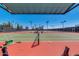 Expansive tennis courts under a clear blue sky, with ample lighting and a fenced perimeter for secure play at 4401 E Walatowa St, Phoenix, AZ 85044
