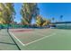 Exterior view of well-maintained tennis courts surrounded by mature trees on a sunny day at 4401 E Walatowa St, Phoenix, AZ 85044
