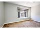 Carpeted bedroom has a window nook with custom curtains and natural light at 4465 E Paradise Village S Pkwy # 1179, Phoenix, AZ 85032