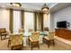 Bright dining room featuring a glass table, cushioned chairs, neutral colors, and recessed lighting at 4465 E Paradise Village S Pkwy # 1179, Phoenix, AZ 85032