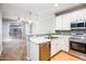Modern kitchen featuring white cabinets, stainless steel appliances, and an open floor plan at 4465 E Paradise Village S Pkwy # 1179, Phoenix, AZ 85032
