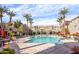 Resort-style pool area surrounded by palm trees, lounge chairs, and well-maintained landscaping at 4465 E Paradise Village S Pkwy # 1179, Phoenix, AZ 85032