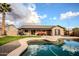 Beautiful backyard with a sparkling pool, a covered patio with seating, and well-maintained landscaping at 502 N 110Th St, Mesa, AZ 85207