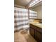 Cozy bathroom with granite countertop vanity, framed mirror, neutral tile floors, and a shower at 502 N 110Th St, Mesa, AZ 85207
