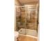 Bathroom features a walk-in shower with stone-style tile and glass doors at 502 N 110Th St, Mesa, AZ 85207