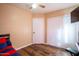 This bedroom offers wood floors, closet, ceiling fan and fresh paint at 502 N 110Th St, Mesa, AZ 85207