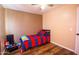Bedroom featuring wood floors, ceiling fan, and playful decor with red and blue bedding at 502 N 110Th St, Mesa, AZ 85207