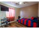 Bedroom with hardwood floors, ceiling fan, and large window with a view of the outside at 502 N 110Th St, Mesa, AZ 85207
