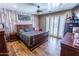 Bedroom with a rustic wood accent wall, ceiling fan and dresser at 502 N 110Th St, Mesa, AZ 85207