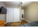 This bedroom features wood floors, ceiling fan, flat screen TV, closet and fresh paint at 502 N 110Th St, Mesa, AZ 85207