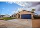 Charming single-story home features a blue garage door, manicured lawn, and ample driveway parking at 502 N 110Th St, Mesa, AZ 85207