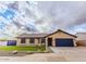 Single-story home with manicured lawn, blue garage door, gravel landscaping, and ample parking space at 502 N 110Th St, Mesa, AZ 85207